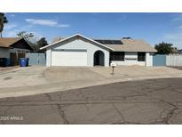 Charming single-story home features a two-car garage, landscaped front yard, and solar panels at 12836 N 39Th Ln, Phoenix, AZ 85029