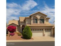 Charming two-story home with a three-car garage and well-maintained landscaping at 21483 N 65Th Ave, Glendale, AZ 85308