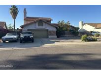 Charming two-story home featuring a tile roof, two-car garage, and desert landscaping at 6030 W Beverly Ln, Glendale, AZ 85306