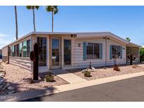 Inviting home with desert landscaping, covered carport, and bright exterior paint scheme at 661 S Hawes Rd # 81, Mesa, AZ 85208