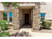 Inviting front entrance featuring a stone facade, brick pathway, and well-maintained landscaping at 882 E Parkview Dr, Gilbert, AZ 85295