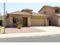 Charming single-story home featuring a low-maintenance desert landscape and a two-car garage at 3559 N 143Rd Ave, Goodyear, AZ 85395
