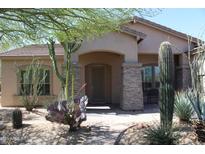 Charming single-story home featuring desert landscaping and a welcoming front porch at 8703 E Nora St, Mesa, AZ 85207