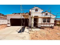 New construction home featuring a two-car garage and a modern architectural design at 11946 E Cliffrose Ln, Florence, AZ 85132