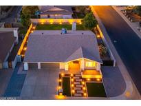 Beautifully landscaped home exterior with manicured lawn, lighted walkway, and a two-car garage at 2178 E La Jolla Dr, Tempe, AZ 85282