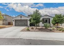 Charming single-story home featuring a two-car garage and desert landscaping at 21840 N 260Th Ln, Buckeye, AZ 85396
