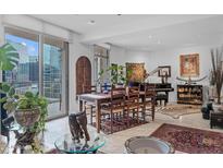 Bright living area with large windows, a dining table, and a piano, perfect for entertaining at 2402 E Esplanade Ln # 604, Phoenix, AZ 85016