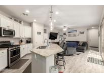 Bright, open living area featuring a modern kitchen, comfortable seating, and an airy design at 4355 E Dennisport Ave, Gilbert, AZ 85295