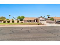 Charming single-story home featuring a well-manicured lawn and a two-car garage with inviting curb appeal at 1210 W Stottler Dr, Chandler, AZ 85224