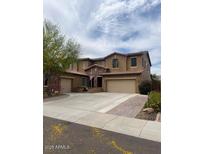Charming two-story home with a three-car garage and a well-manicured front yard in a nice neighborhood at 12518 W Milton Dr, Peoria, AZ 85383