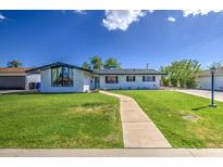 Charming single-story home with lush green lawn, walkway, and freshly painted exterior for great curb appeal at 1263 W Devonshire St, Mesa, AZ 85201