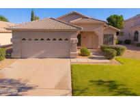 Charming single-story home featuring a well-maintained lawn and a two-car garage at 1463 W Mead Dr, Chandler, AZ 85248