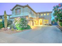 Charming two-story home features a well-maintained yard with lush landscaping and a welcoming entrance at 17009 S Coleman St, Phoenix, AZ 85045