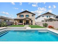 Backyard pool with a manicured lawn and covered patio enhances this home's outdoor space at 22499 E Mewes Rd, Queen Creek, AZ 85142