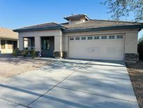 Charming single-story home with a two car garage and desert landscaping at 25386 W Darrel Dr, Buckeye, AZ 85326