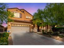 Charming home with a large driveway, a two-car garage, and desert landscaping at 2930 E Quiet Hollow Ln, Phoenix, AZ 85024