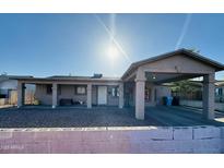 Charming single-story home with a covered parking and desert landscaping in the front yard at 3806 N 80Th Dr, Phoenix, AZ 85033