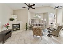 Bright living room with tile floors, fireplace, ceiling fans, and lots of natural light at 4202 E Broadway Rd # 40, Mesa, AZ 85206