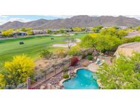 Overhead view of a refreshing pool and landscaping overlooking a lush green golf course at 42102 N Long Cove Way, Phoenix, AZ 85086