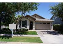 Charming single-story home featuring a well-manicured lawn, mature trees, and a two-car garage at 4336 E Mesquite St, Gilbert, AZ 85296
