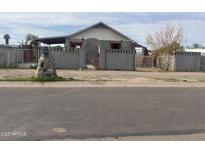 Quaint single story home featuring a gated front yard and stone accents in a residential area at 509 W 12Th St, Casa Grande, AZ 85122