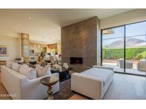 Open-concept living room featuring a modern fireplace, sleek furniture, and seamless indoor-outdoor flow at 5434 E Lincoln Dr # 58, Paradise Valley, AZ 85253