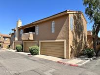 Two-story townhouse featuring private garages and neutral stucco, perfect for a low-maintenance lifestyle at 5640 E Bell Rd # 1098, Scottsdale, AZ 85254