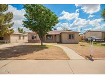 Charming single-story home with a well-manicured front yard and walkway at 6231 S 2Nd Ave, Phoenix, AZ 85041