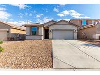 Charming single-story home with a well-maintained yard and a spacious two-car garage at 11505 W Boca Raton Rd, El Mirage, AZ 85335