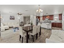 Open-concept space showcasing living and dining areas, connecting seamlessly to a kitchen island with bar seating at 1317 N Balboa --, Mesa, AZ 85205