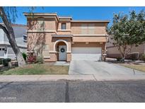 Charming two-story home featuring a well-manicured front yard, garage, and decorative entrance at 2109 S Luther --, Mesa, AZ 85209