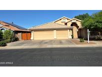 Charming home featuring a three-car garage, desert landscaping, and a tile roof at 2434 S Colleen --, Mesa, AZ 85210