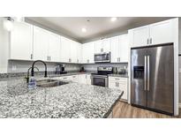 Beautiful kitchen with white cabinets, stainless steel appliances, and a large granite countertop island at 2821 S Skyline Dr # 156, Mesa, AZ 85212