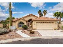 Charming single-story home featuring a two-car garage, desert landscaping, and a red tile roof at 3700 N 149Th Ln, Goodyear, AZ 85395