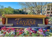 Welcoming Toscana of Desert Ridge community sign with vibrant flowerbeds and manicured landscaping at 5350 E Deer Valley Dr # 4268, Phoenix, AZ 85054
