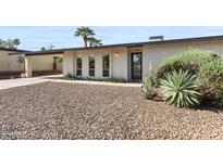 Charming home featuring desert landscaping and a well-maintained facade with a covered parking area at 845 E Village Circle S Dr, Phoenix, AZ 85022