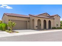Charming single-story home with a two-car garage, arched entryway, and red tile roof at 17279 W Dartmouth St, Surprise, AZ 85388