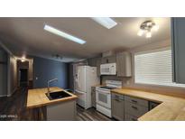 Bright kitchen features modern appliances, ample cabinet space, and a butcher block island at 2400 E Baseline Ave # 144, Apache Junction, AZ 85119