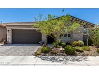 Charming single-story home featuring desert landscaping, stone accents, and a two-car garage at 2835 E Donald Dr, Phoenix, AZ 85050