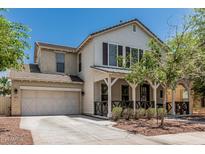 Charming two-story home with a welcoming front porch, well-manicured landscaping, and a convenient two-car garage at 3109 N Black Rock Rd, Buckeye, AZ 85396