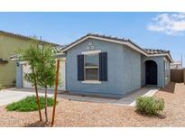 Charming home featuring stucco exterior, desert landscaping, and a welcoming front entrance at 36463 W San Alvarez Ave, Maricopa, AZ 85138