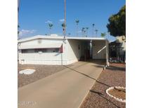 Charming single-story home with a driveway and mature palm trees in a well-maintained community at 4065 E University Dr # 240, Mesa, AZ 85205