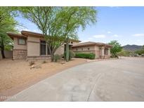 Stunning single-story home featuring lush landscaping and a private driveway at 4684 E Coachwhip Rd, Cave Creek, AZ 85331