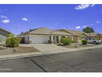 Charming single-story home featuring desert landscaping, tile roof, covered porch, and two-car garage at 7832 E Osage Ave, Mesa, AZ 85212