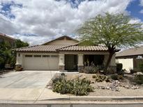 Charming single-story home with a desert landscaped front yard and a two-car garage at 830 E Dry Creek Rd, San Tan Valley, AZ 85143