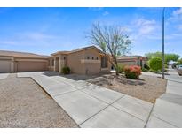 Charming single-story home featuring a well-maintained landscape and a long driveway at 8745 W Windsor Dr, Peoria, AZ 85381