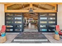 Inviting entrance with modern door, wood ceiling, and glimpses into the spacious living area at 11119 W Mountain View Rd, Sun City, AZ 85351