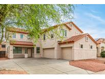 Charming two-story home with a three-car garage and a tile roof at 16215 W Durango St, Goodyear, AZ 85338