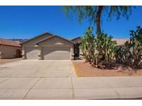 Charming single-story home features a three-car garage and desert landscaping at 16768 W Nottingham Way, Surprise, AZ 85374