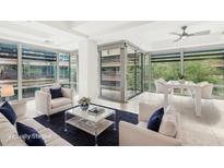 Bright living room boasts a statement wall of windows, modern furnishings, and ample space at 7131 E Rancho Vista Dr # 3001, Scottsdale, AZ 85251